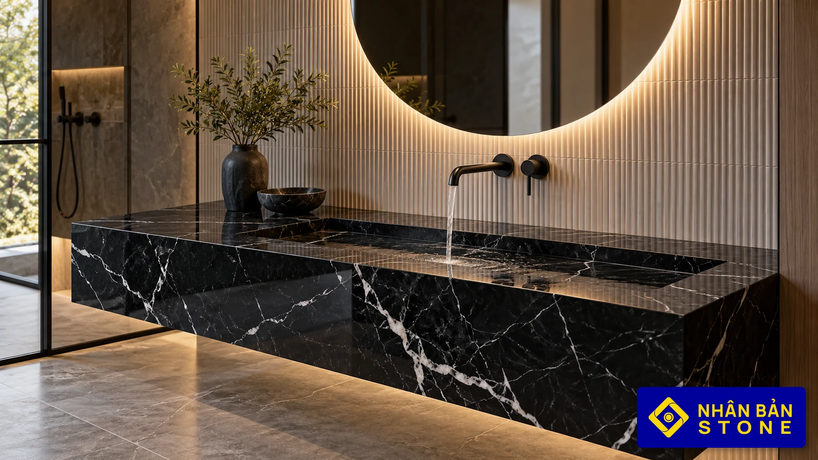 Illustrative image: Black Marquina marble vanity with integrated sloped trough basin and concealed slot drain – NHAN BAN STONE